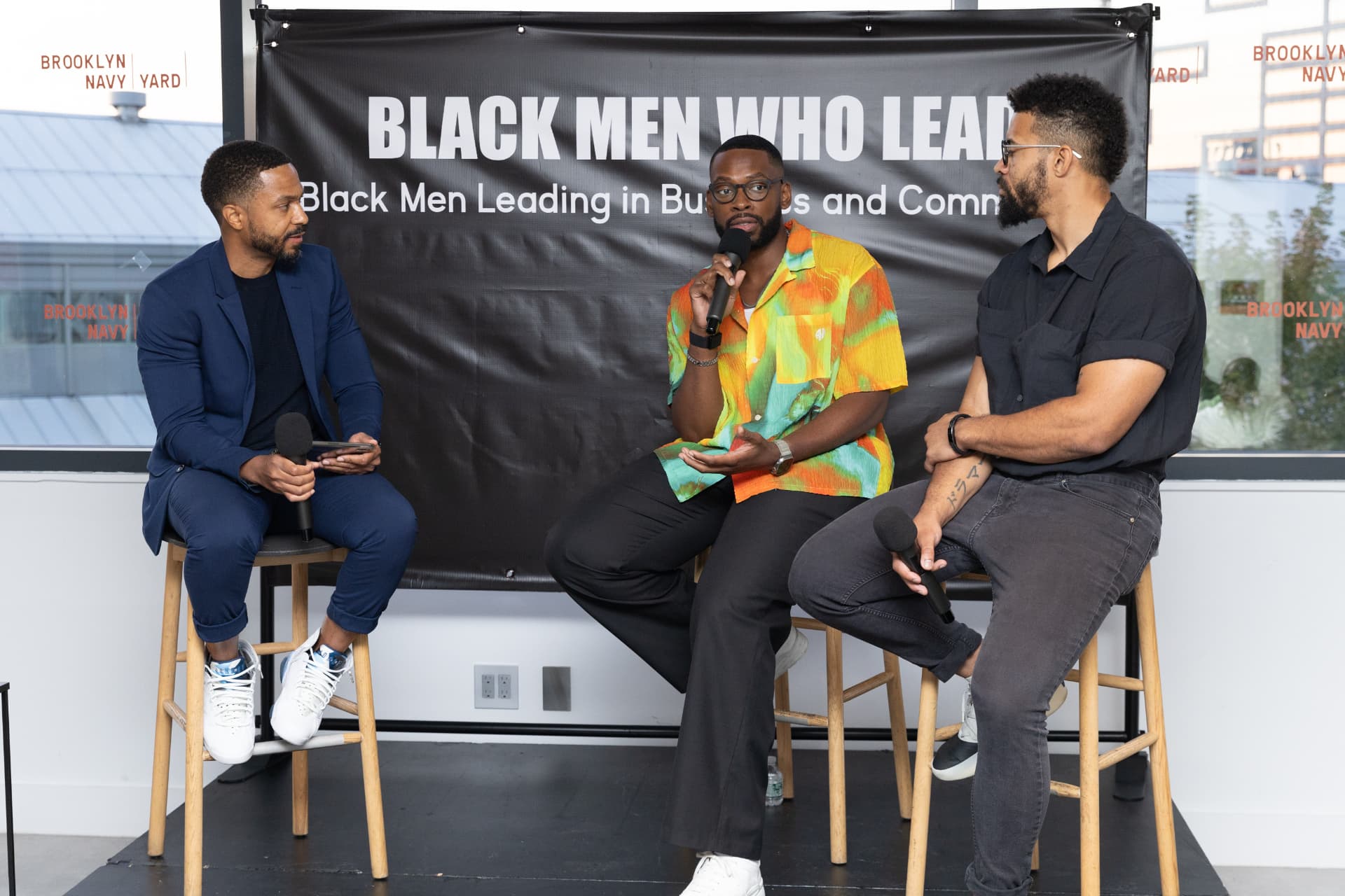 Aquaus Kelley on stage at the Black Men Who Lead event in Brooklyn
