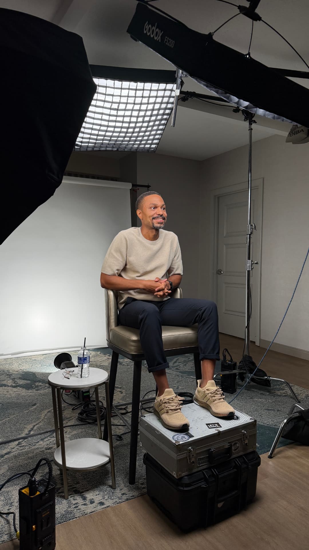 Aquaus Kelley seated in a studio during a video shoot